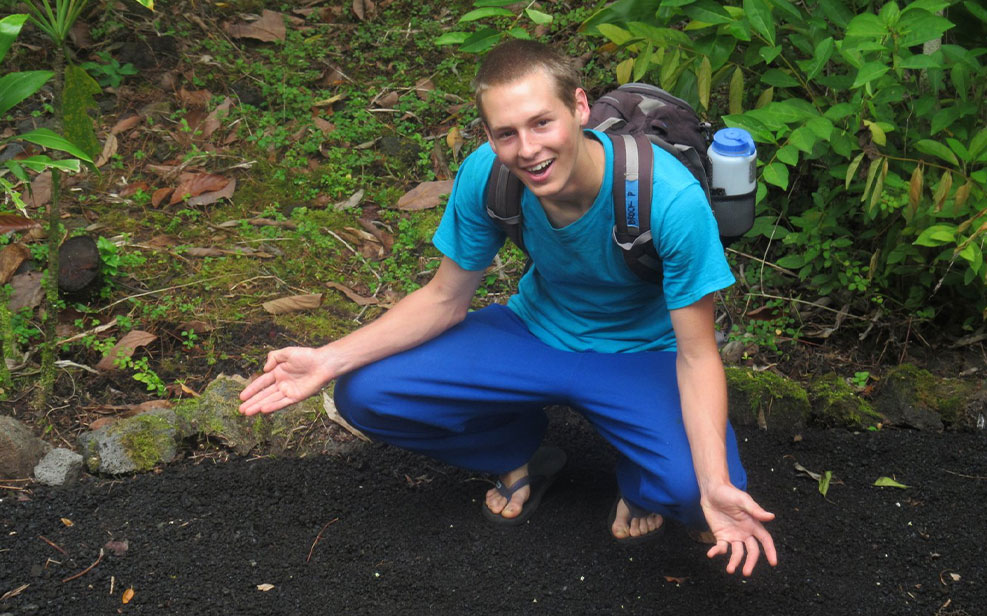 young adult student in the garden; outdoor behavioral health programs